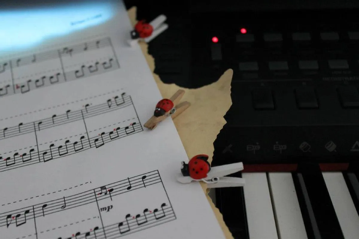 Partituras con pinzas decorativas sobre un teclado